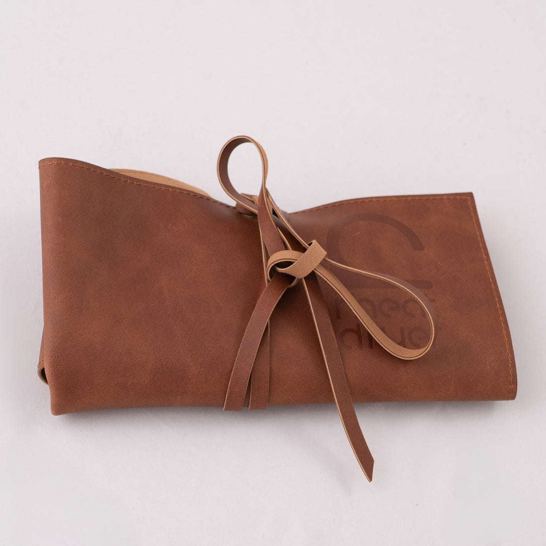 Brown roll with a ribbon on a white background