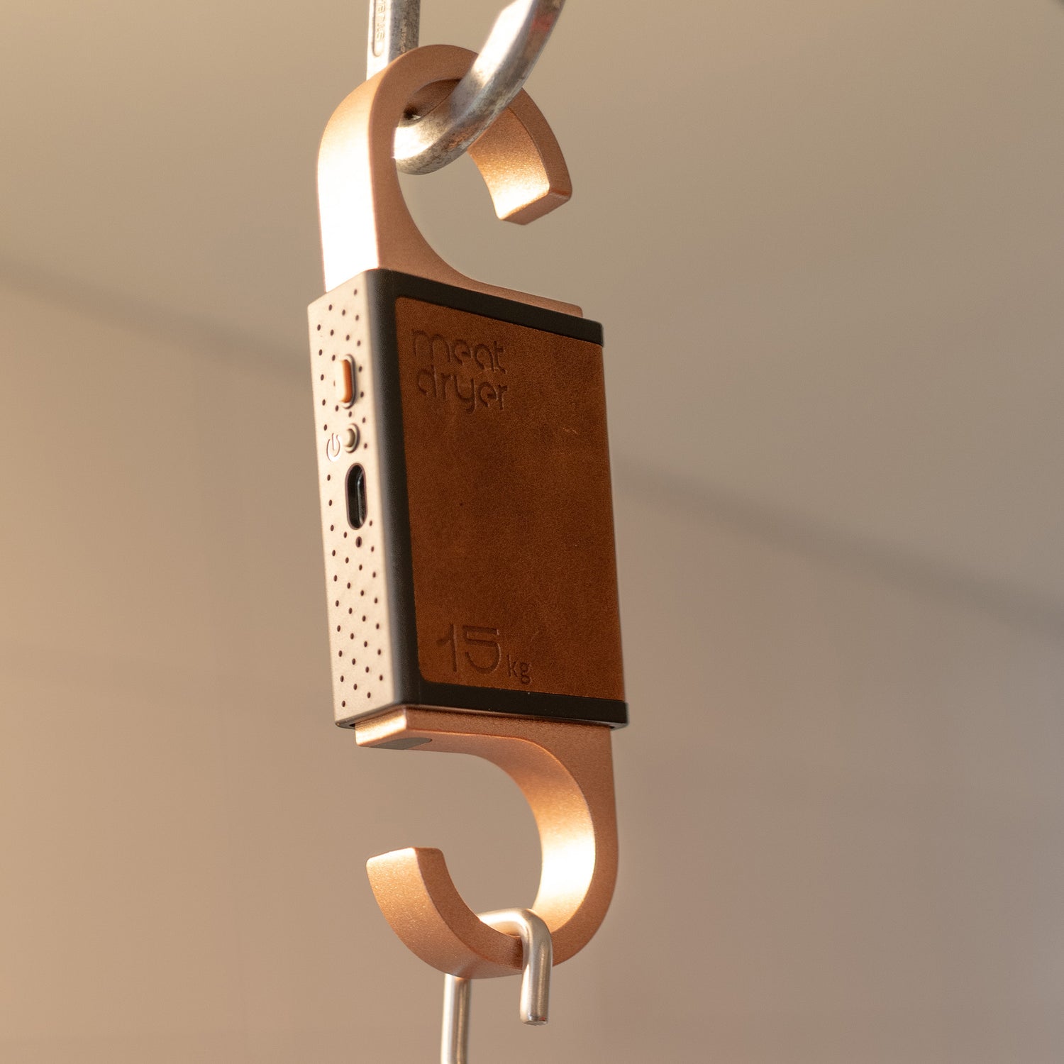 Smart meat hook with copper and brown design hanging in a metal carabiner